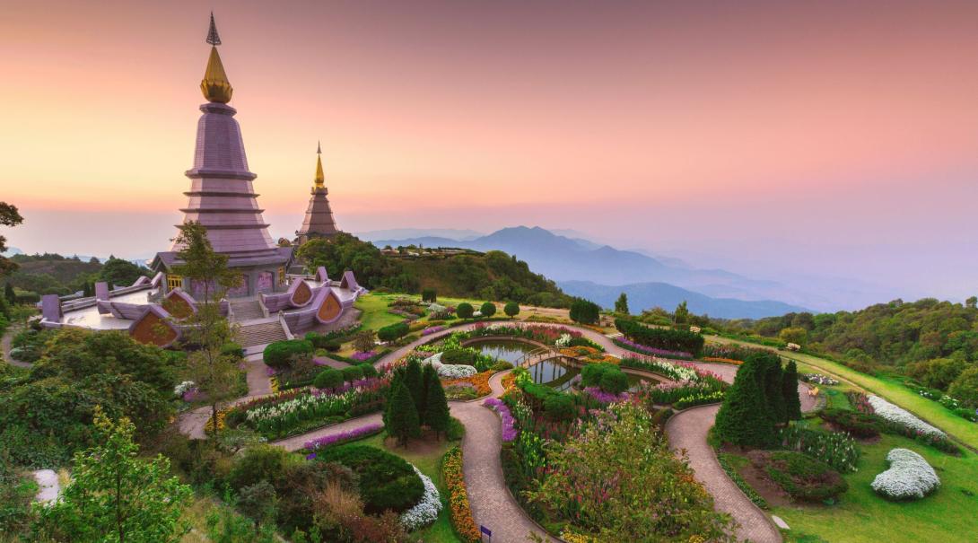 A sunset view of a traditional building and garden set atop the mountains of Chiang Mai 