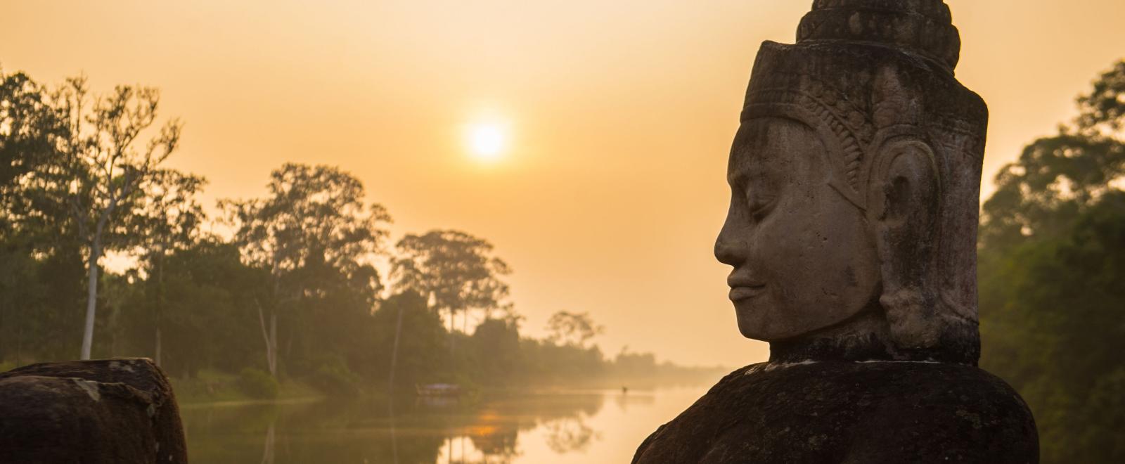 Buddha is shown over a body of water in Angkor Wat, where Projects Abroad volunteers visit and educate themselves on Khmer history.