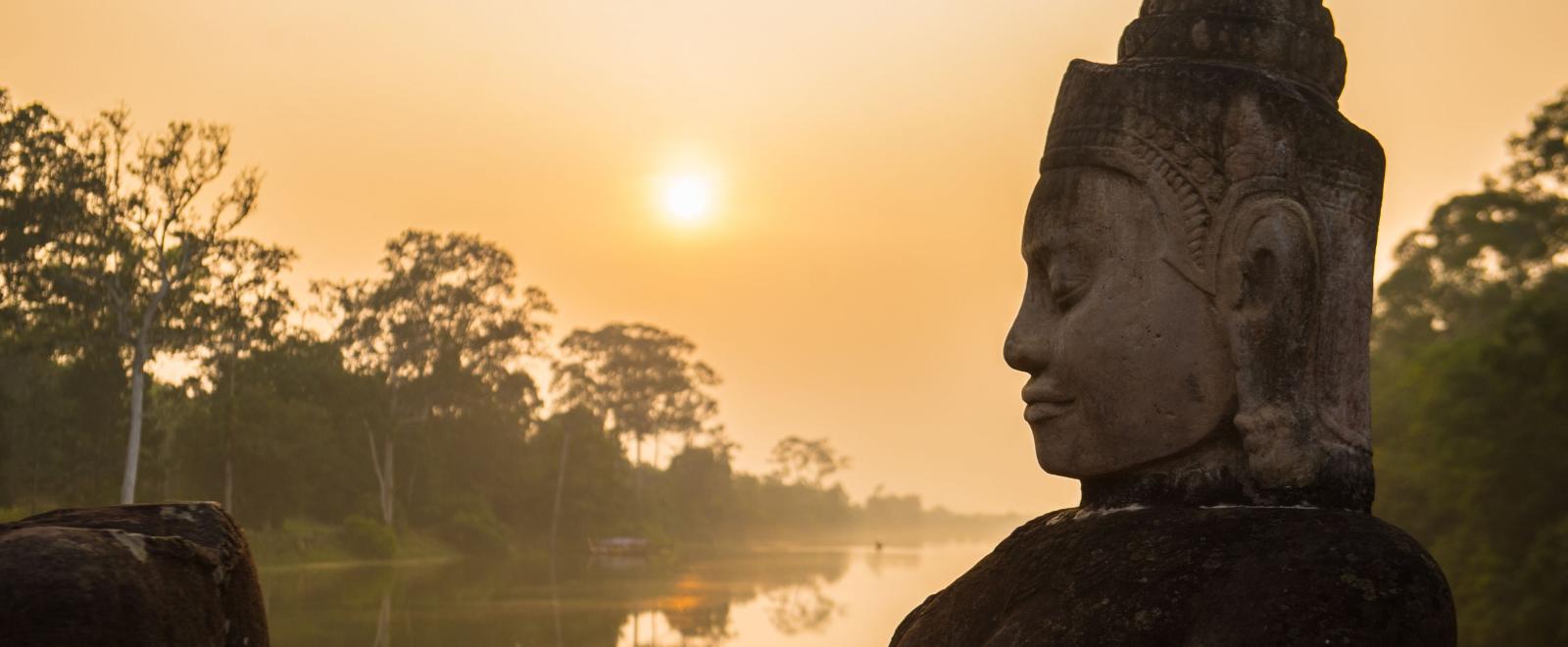 Buddha is shown over a body of water in Angkor Wat, where Projects Abroad volunteers visit and educate themselves on Khmer history.
