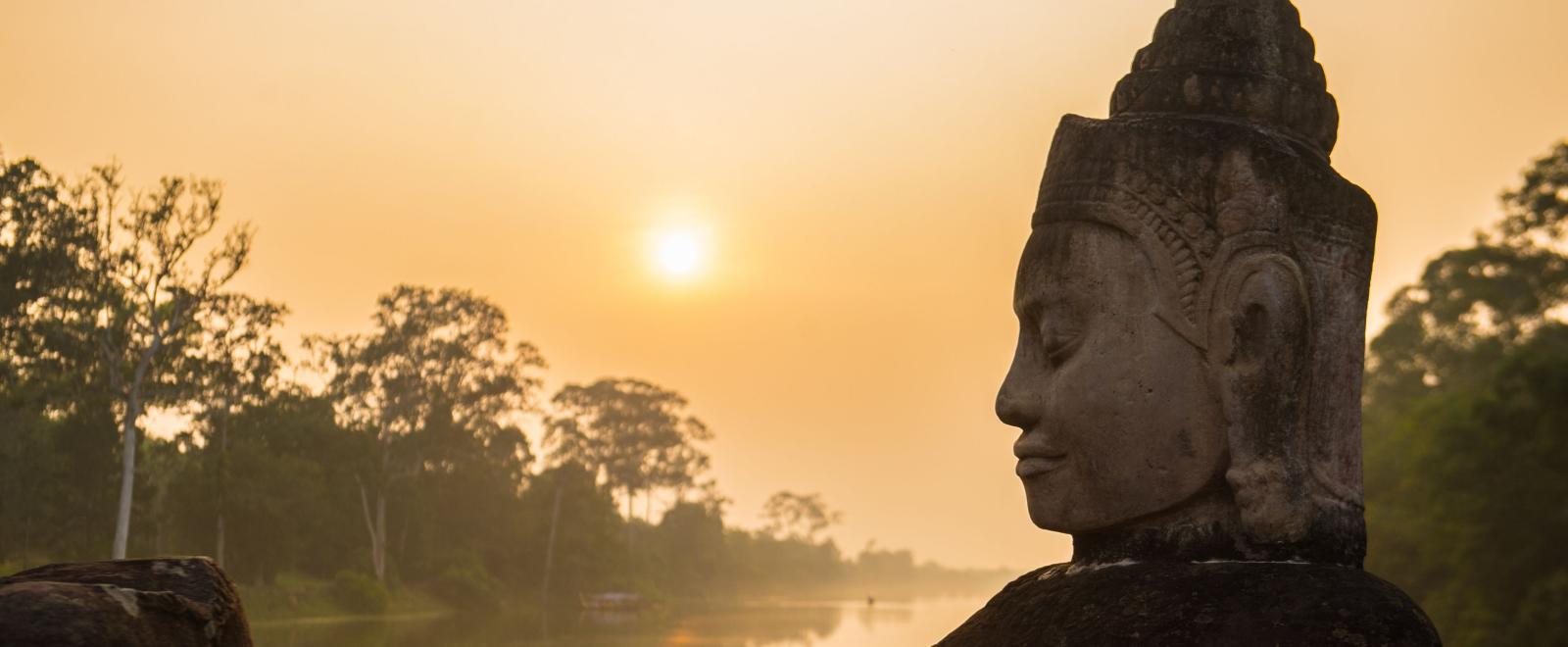 Buddha is shown over a body of water in Angkor Wat, where Projects Abroad volunteers visit and educate themselves on Khmer history.