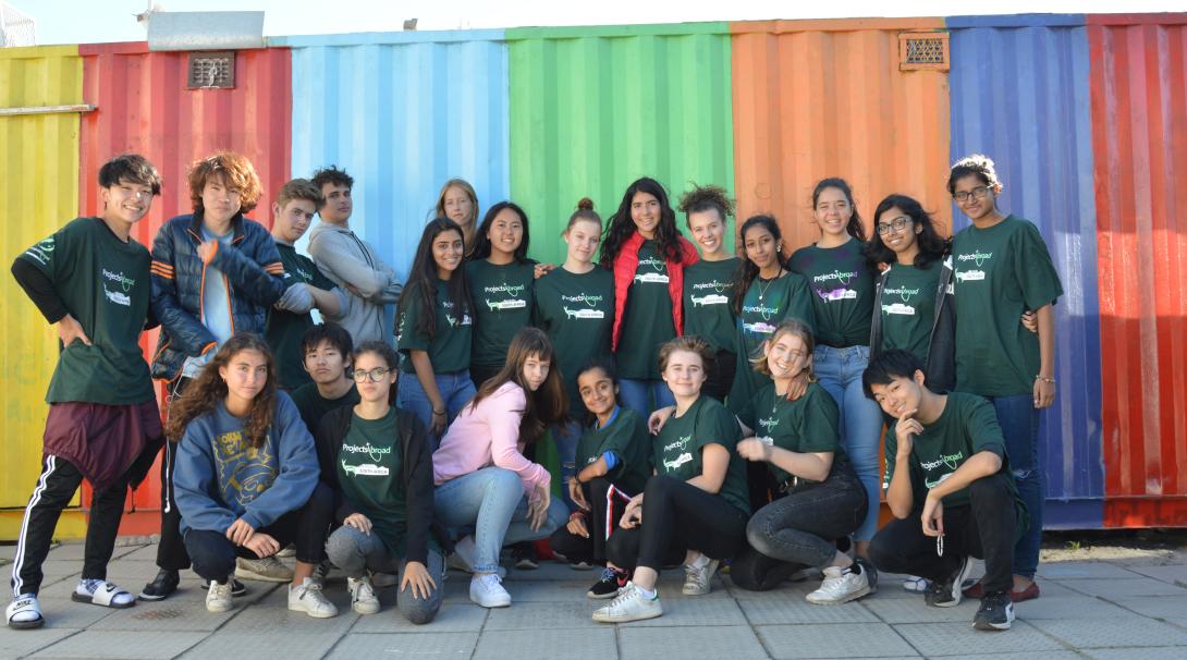 On a volunteer abroad program for high school students, teens relax and take a photo in South Africa. 
