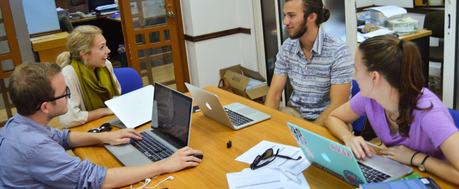 A group of Human Rights interns in Africa have a lively discussion while doing research for a case. 