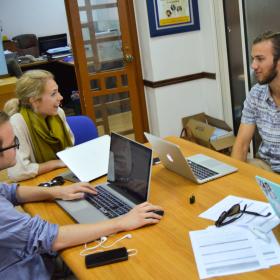 A group of Human Rights interns in Africa have a lively discussion while doing research for a case. 