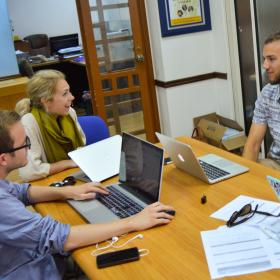 A group of Human Rights interns in Africa have a lively discussion while doing research for a case. 