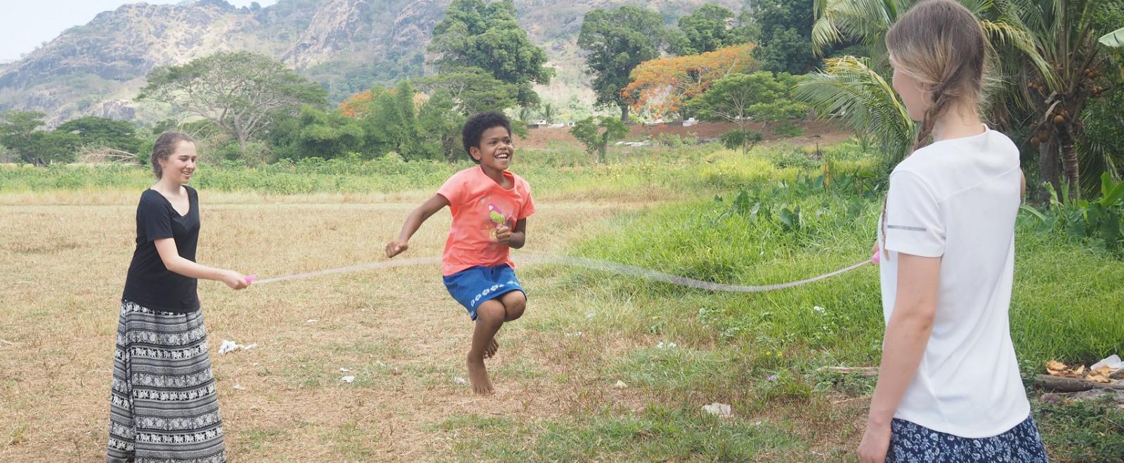 Two sisters playing jumprope with a child on the Projects Abroad Childcare Projecte in Fiji