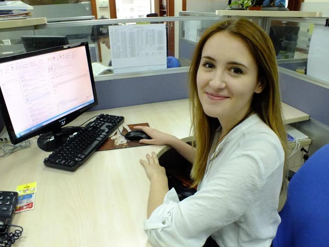On a law internship abroad in China, an intern smiles as she works at her desk