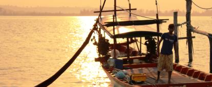 A local fisherman prepares a boat for a group of volunteers on a trip to experience Khmer cultural immersion. 