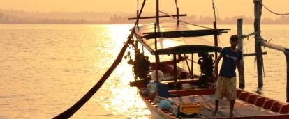 A local fisherman prepares a boat for a group of volunteers on a trip to experience Khmer cultural immersion. 