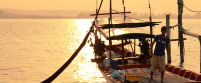 A local fisherman prepares a boat for a group of volunteers on a trip to experience Khmer cultural immersion. 
