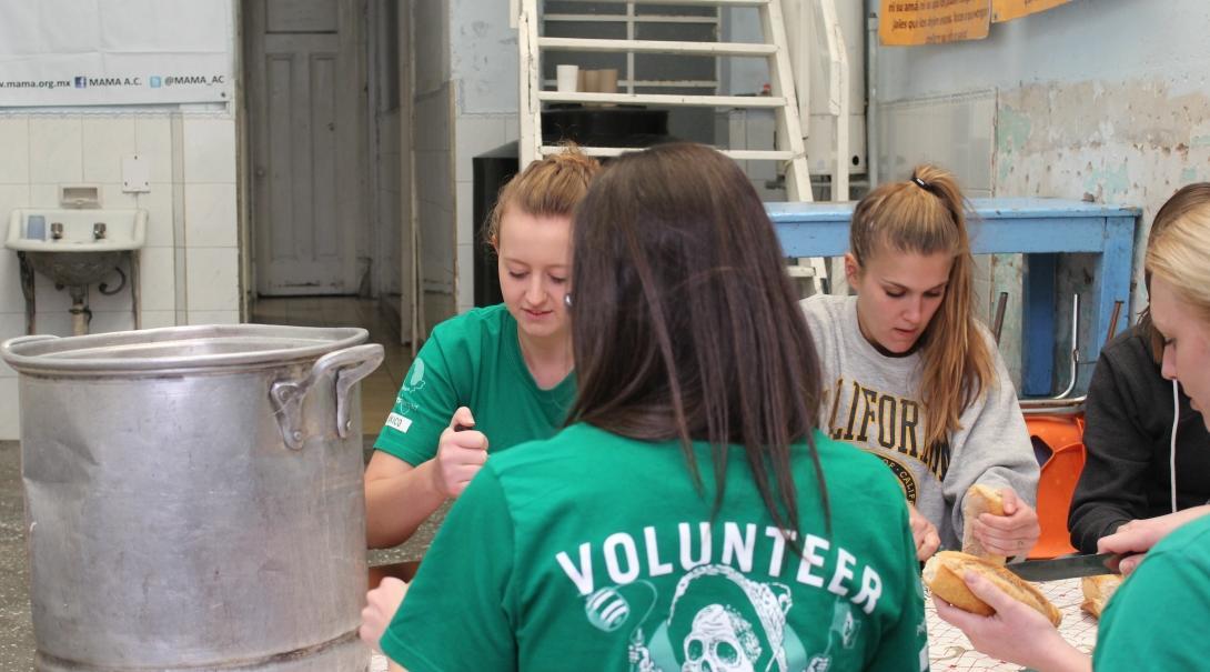 Interns prepare food for an event on one of our International Development internships abroad.