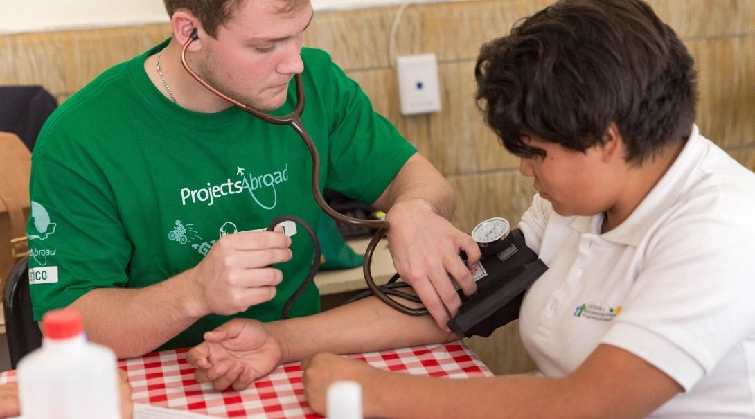 A local woman has her blood pressure measured by a Medicine intern doing a placement abroad in Mexico. 