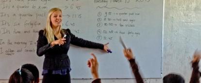 Children learn how to tell the time from a volunteer teaching in Mexico