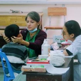 A local child gets a medical check during an outreach from an intern doing her Nursing internship in Vietnam.