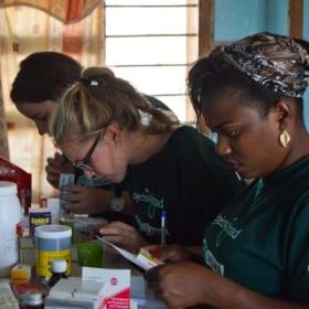 Pharmacy interns in Tanzania sort and label medication needed for a medical outreach.
