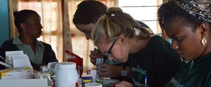 Pharmacy interns in Tanzania sort and label medication needed for a medical outreach.
