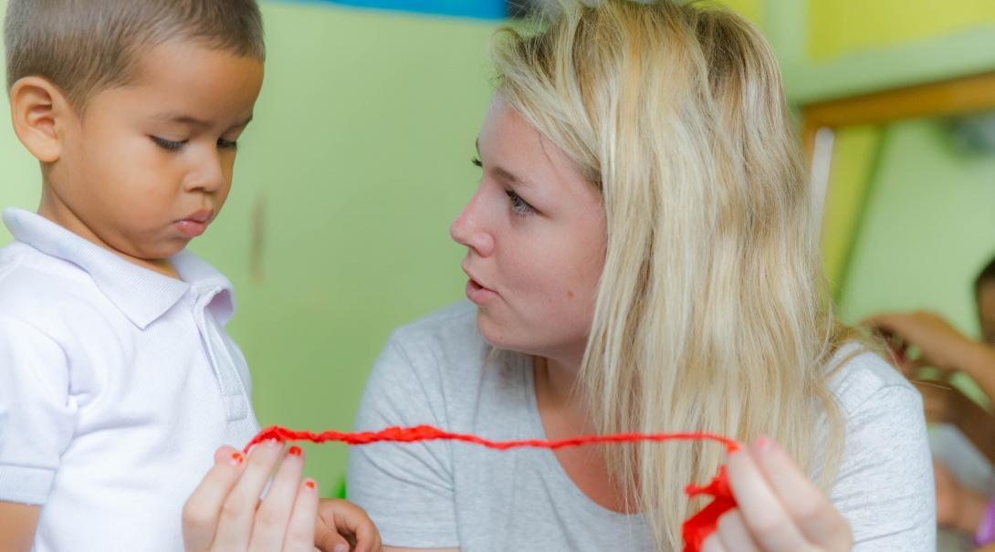 An intern works with a child as part of her international social work.