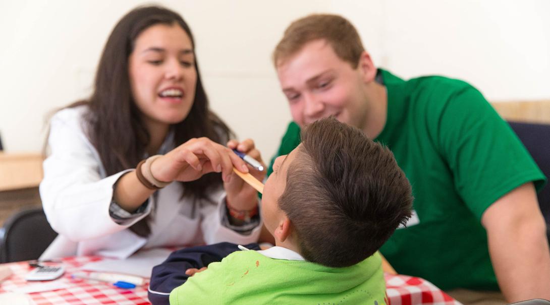 Volunteers checking the health and vitals of a young patient passing through Mexico