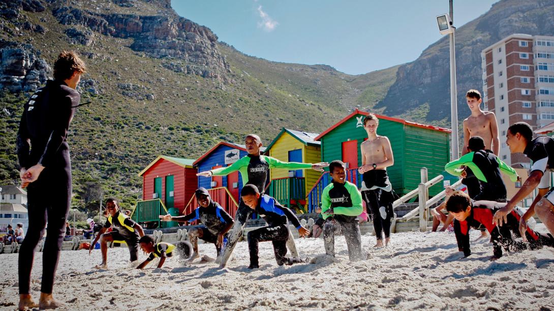 Stretching on the beach in a surfing project, South Africa