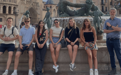 Volunteers sit on a fountain in Valencia, Spain